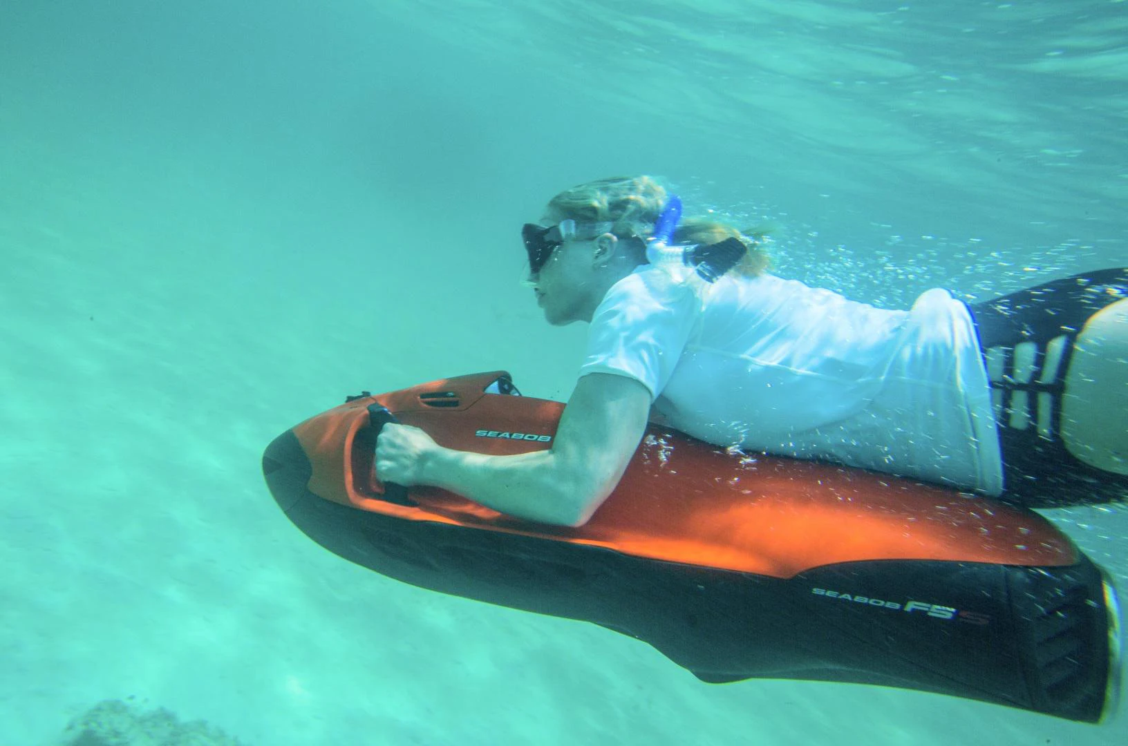 a person in a white dress on a surfboard in the water aboard AMARULA SUN Yacht for Sale