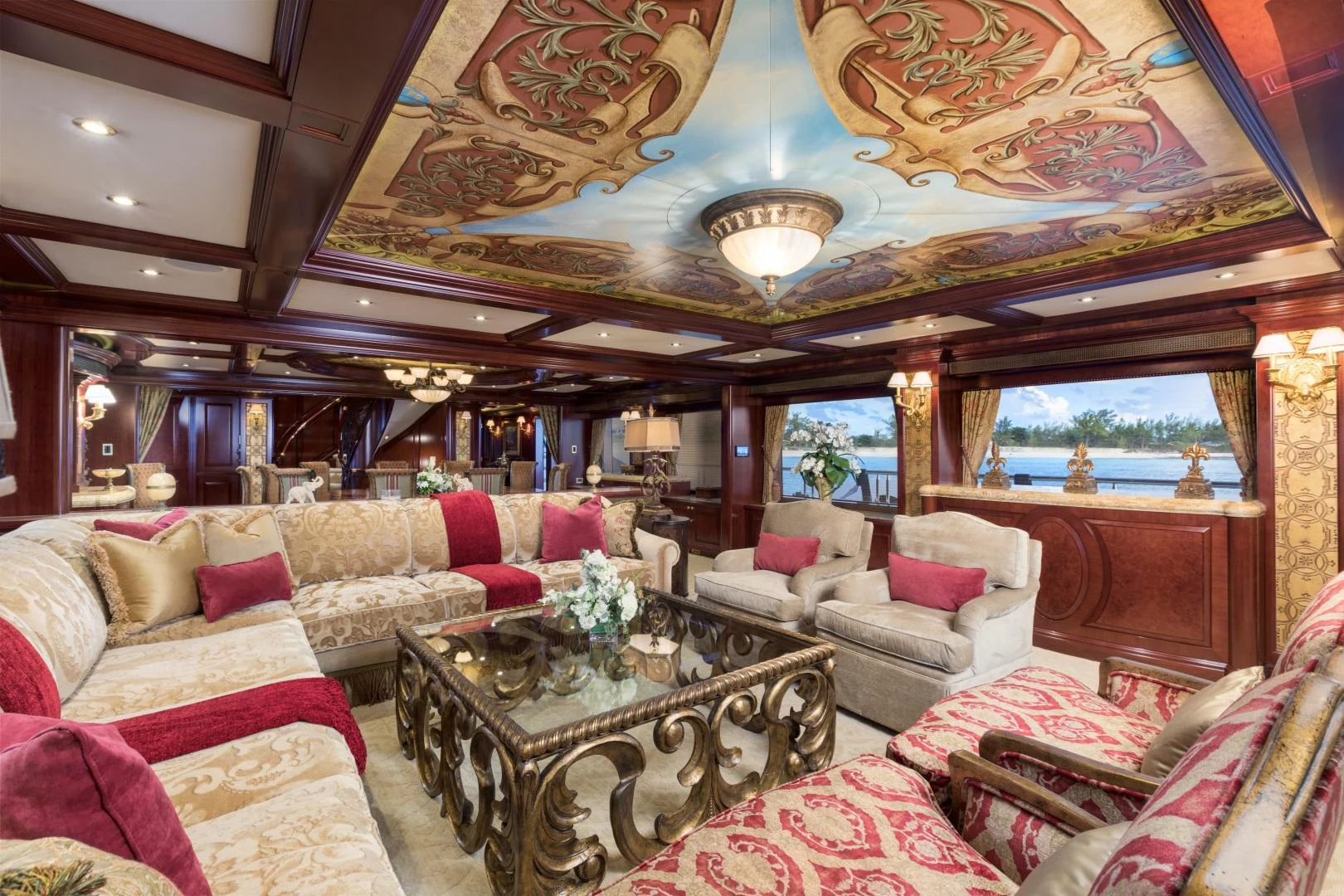 a living room with a large chandelier aboard AMARULA SUN Yacht for Sale