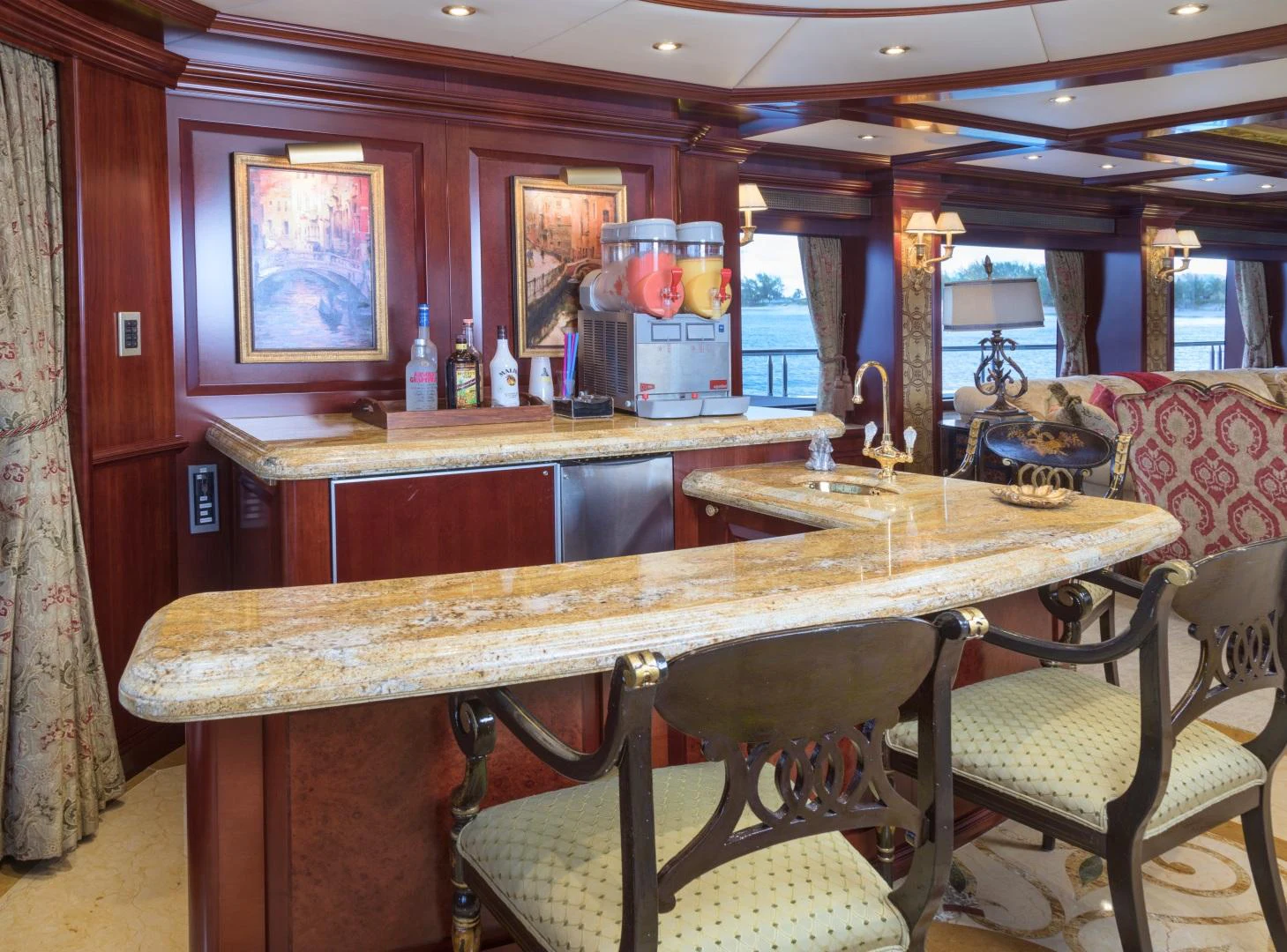 a bar with a table and chairs aboard AMARULA SUN Yacht for Sale
