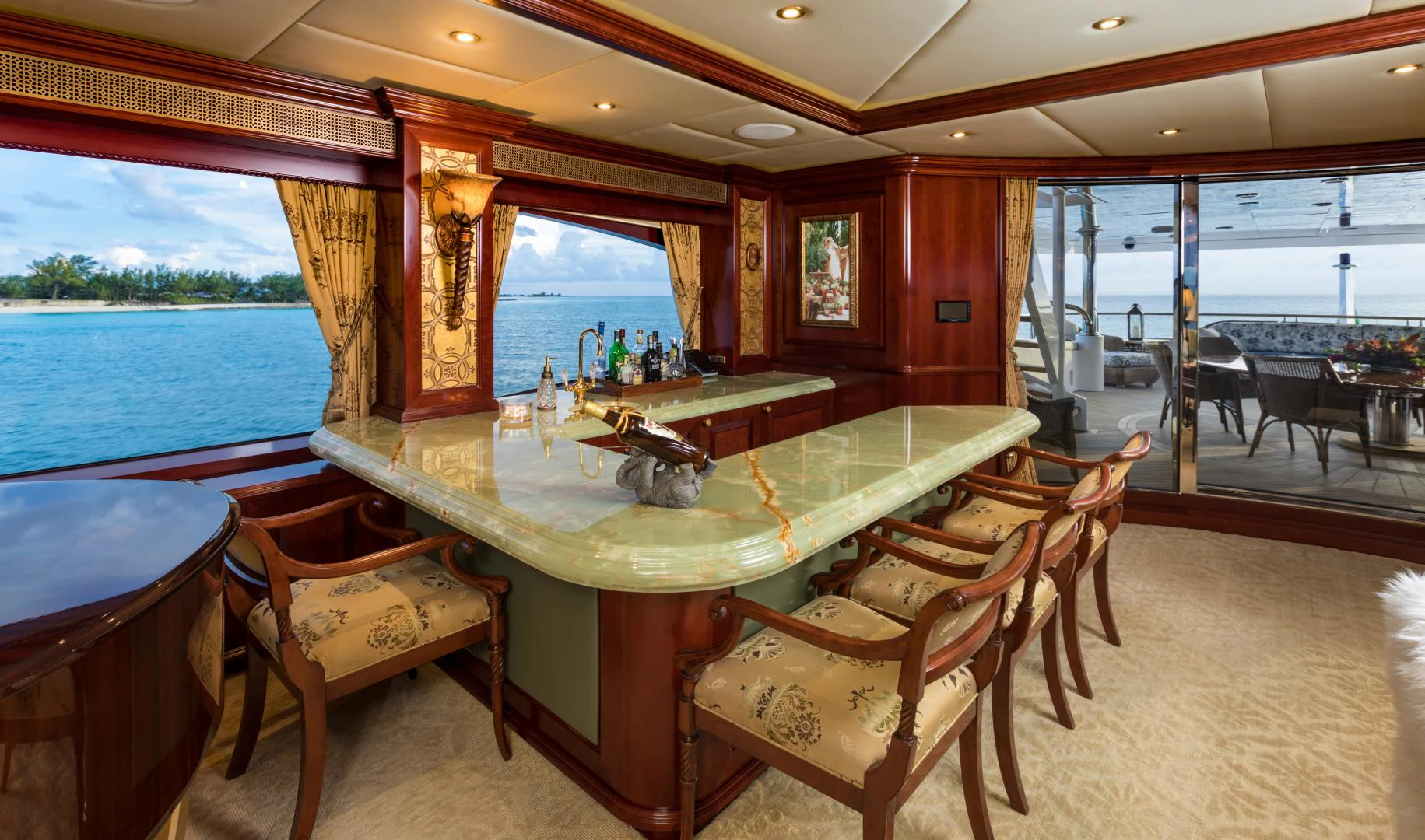 a room with a table chairs and a large window aboard AMARULA SUN Yacht for Sale