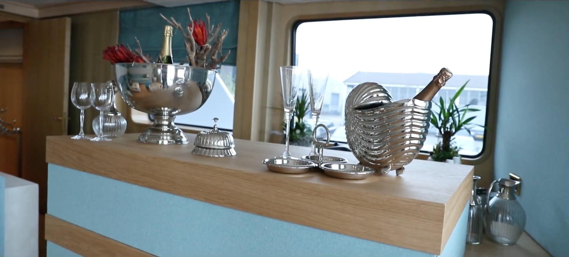 a table with a vase and a basket with flowers in it aboard ANNA J Yacht for Sale