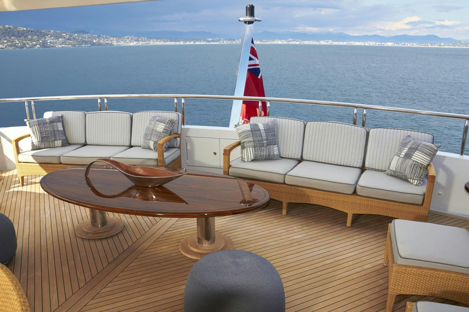 a table and chairs on a deck overlooking a body of water aboard ZOOM ZOOM ZOOM Yacht for Sale