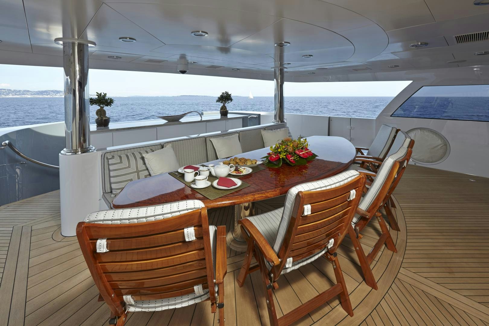 a table with chairs and a view of the ocean aboard ZOOM ZOOM ZOOM Yacht for Sale