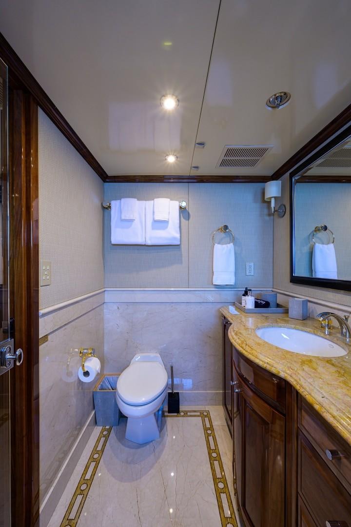 a bathroom with a toilet and a sink aboard REMEMBER WHEN Yacht for Sale