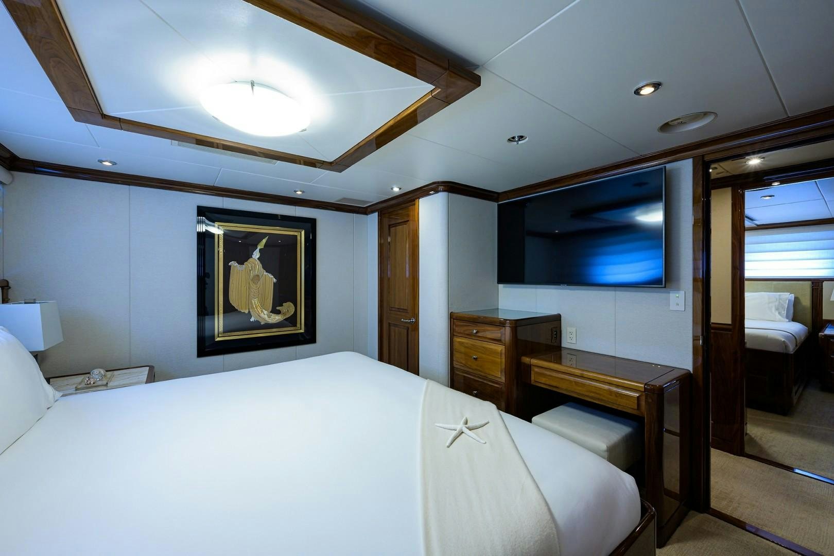 a bedroom with a bed and a desk aboard REMEMBER WHEN Yacht for Sale