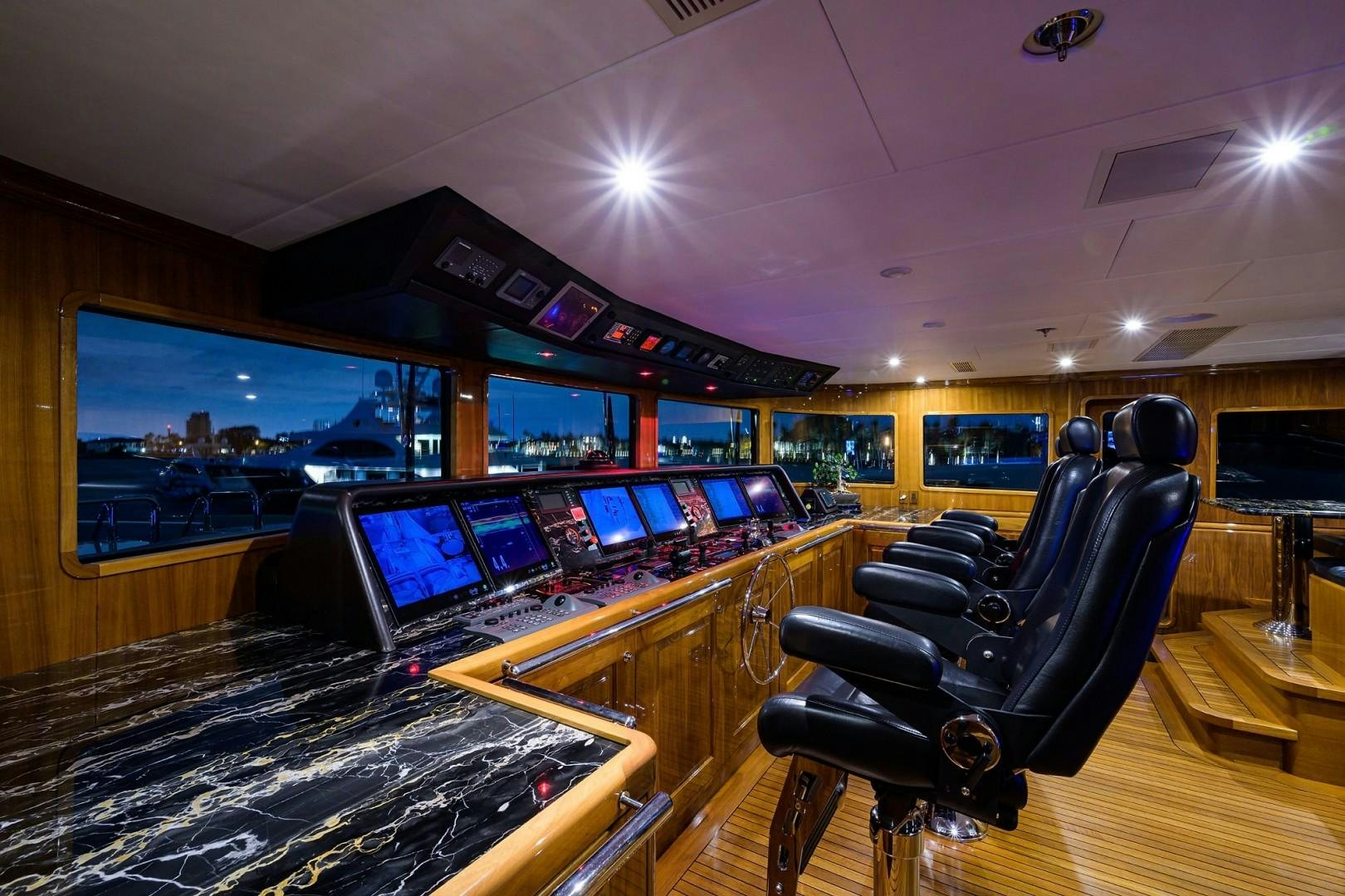 a room with a large table and chairs with computers on it aboard REMEMBER WHEN Yacht for Sale