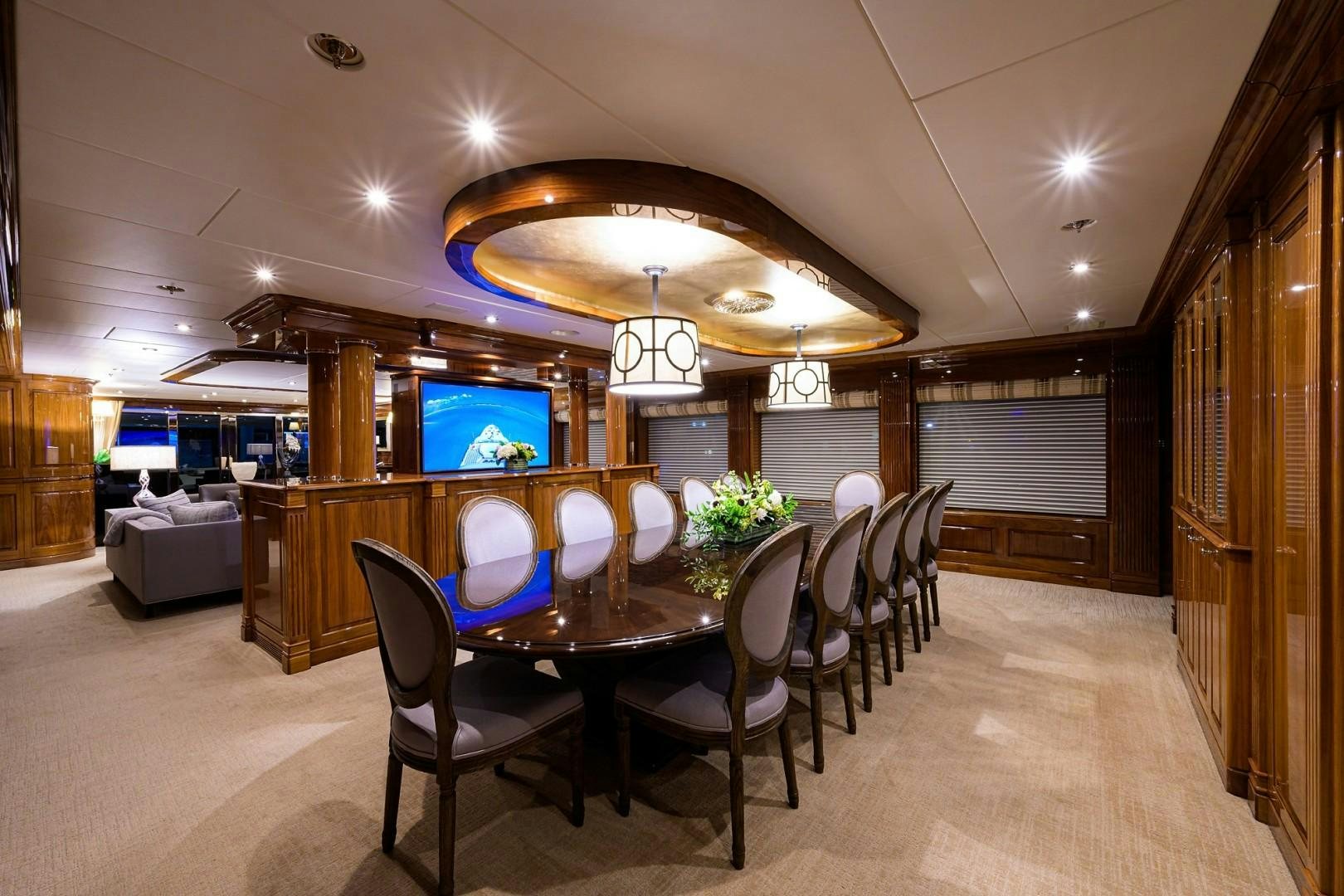 a large dining room with a large screen aboard REMEMBER WHEN Yacht for Sale
