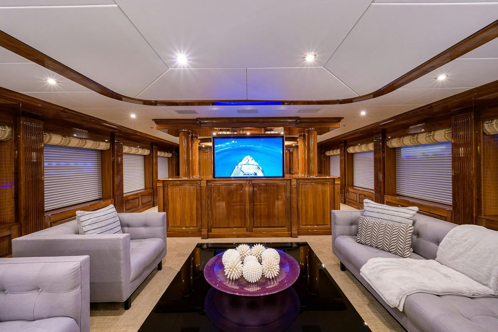 a living room with a tv and a table aboard REMEMBER WHEN Yacht for Sale