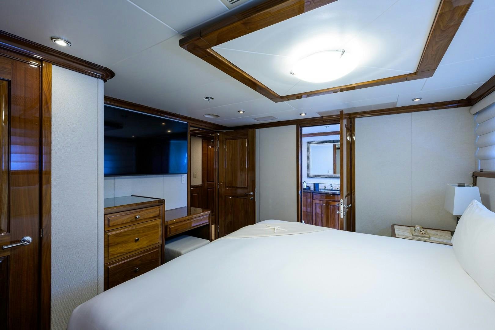 a bedroom with a bed and a desk aboard REMEMBER WHEN Yacht for Sale