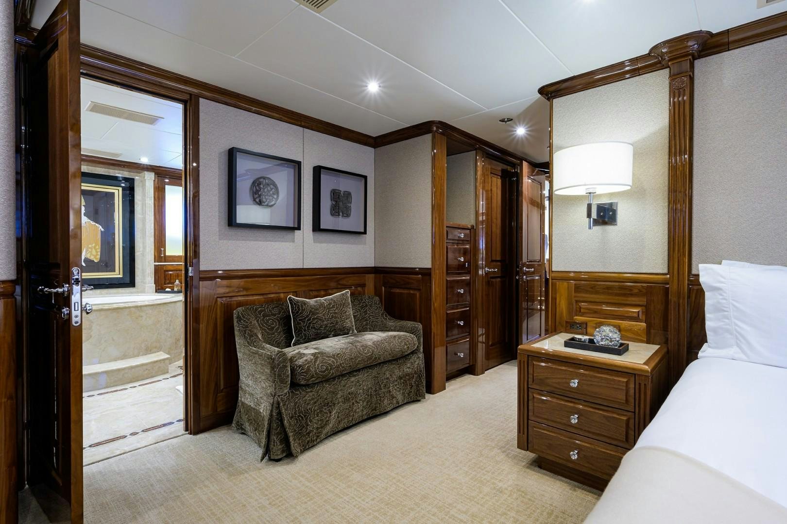 a room with a bed and a chair aboard REMEMBER WHEN Yacht for Sale