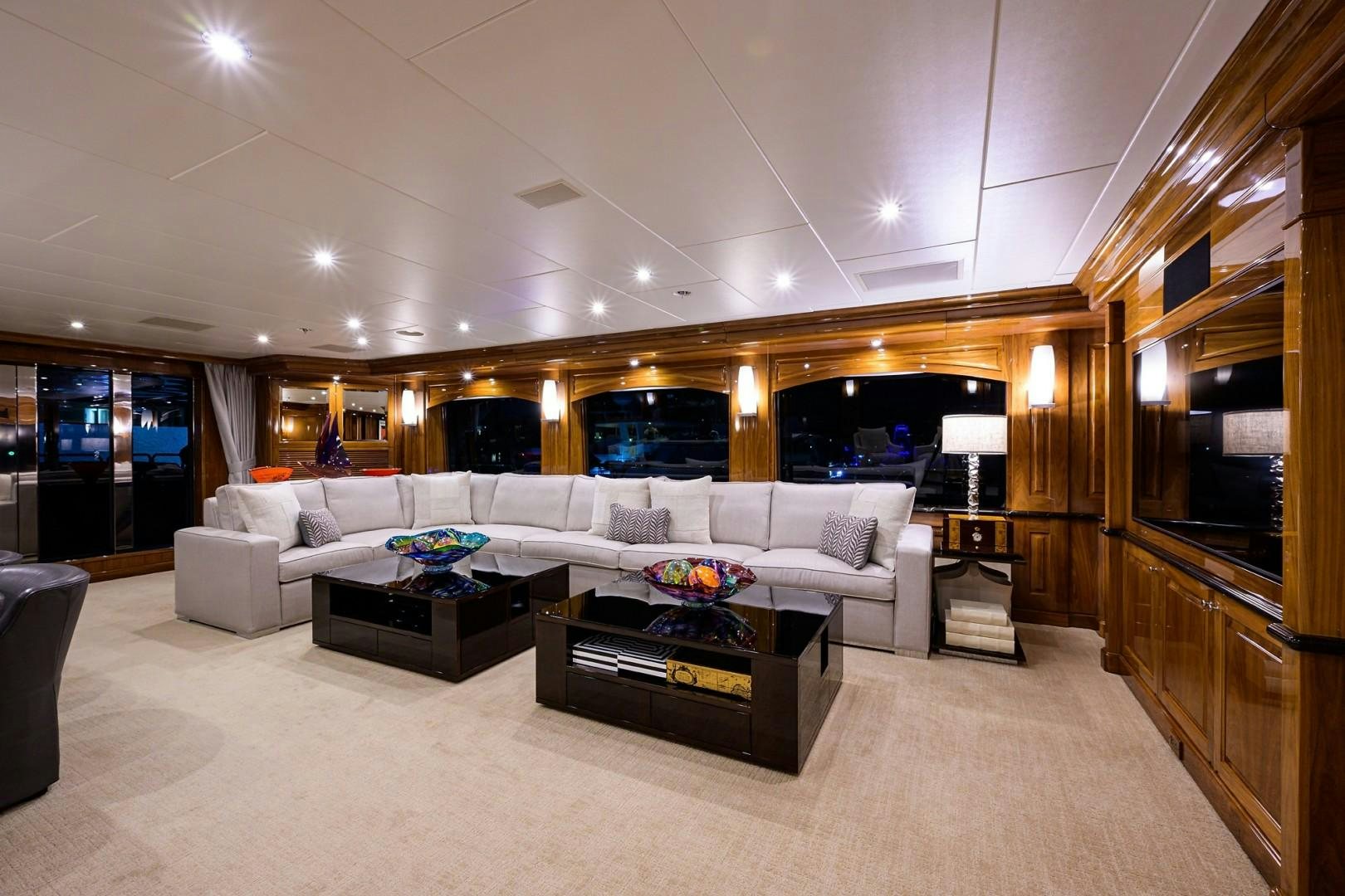 a living room with a large white couch and a large window aboard REMEMBER WHEN Yacht for Sale