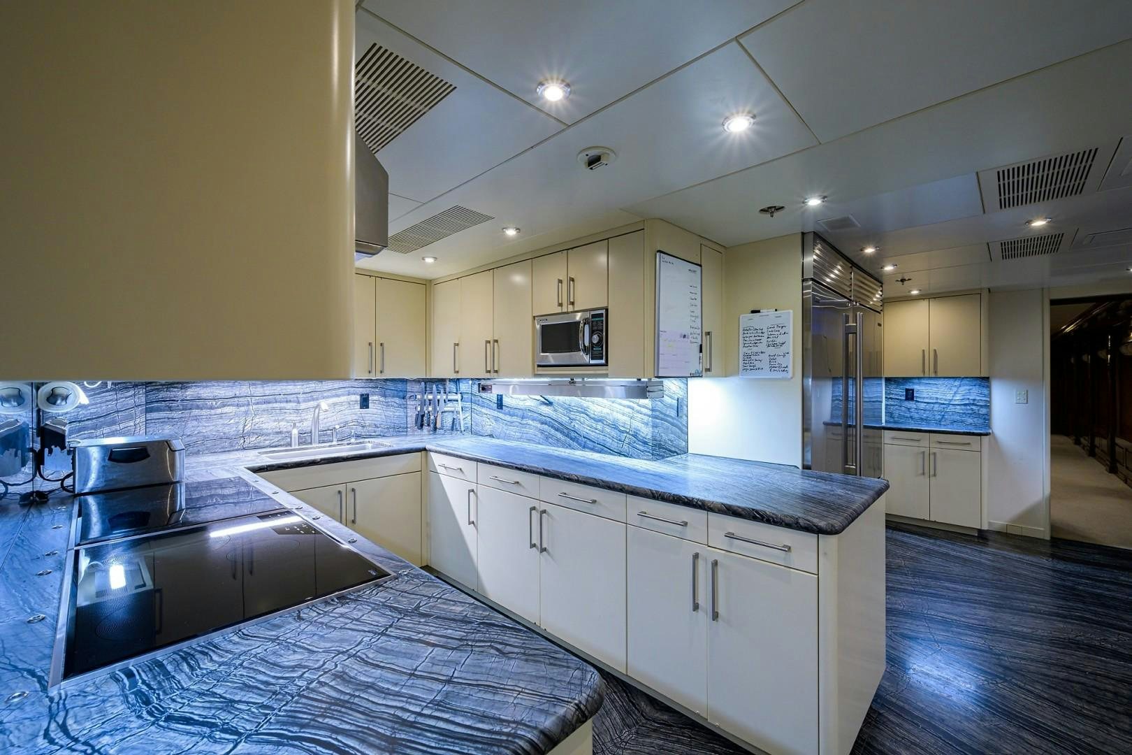 a kitchen with white cabinets aboard REMEMBER WHEN Yacht for Sale