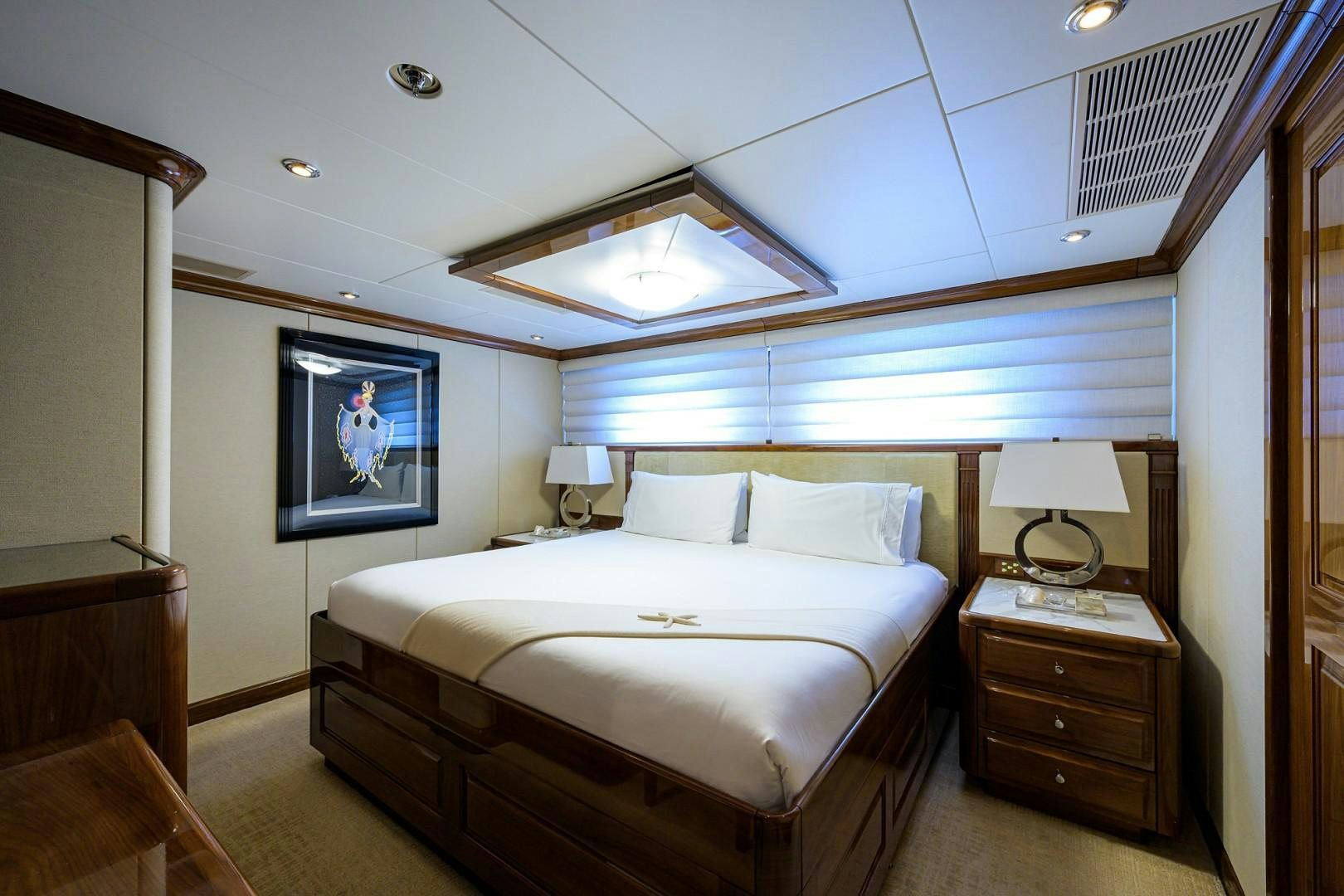 a bedroom with a bed and a lamp aboard REMEMBER WHEN Yacht for Sale