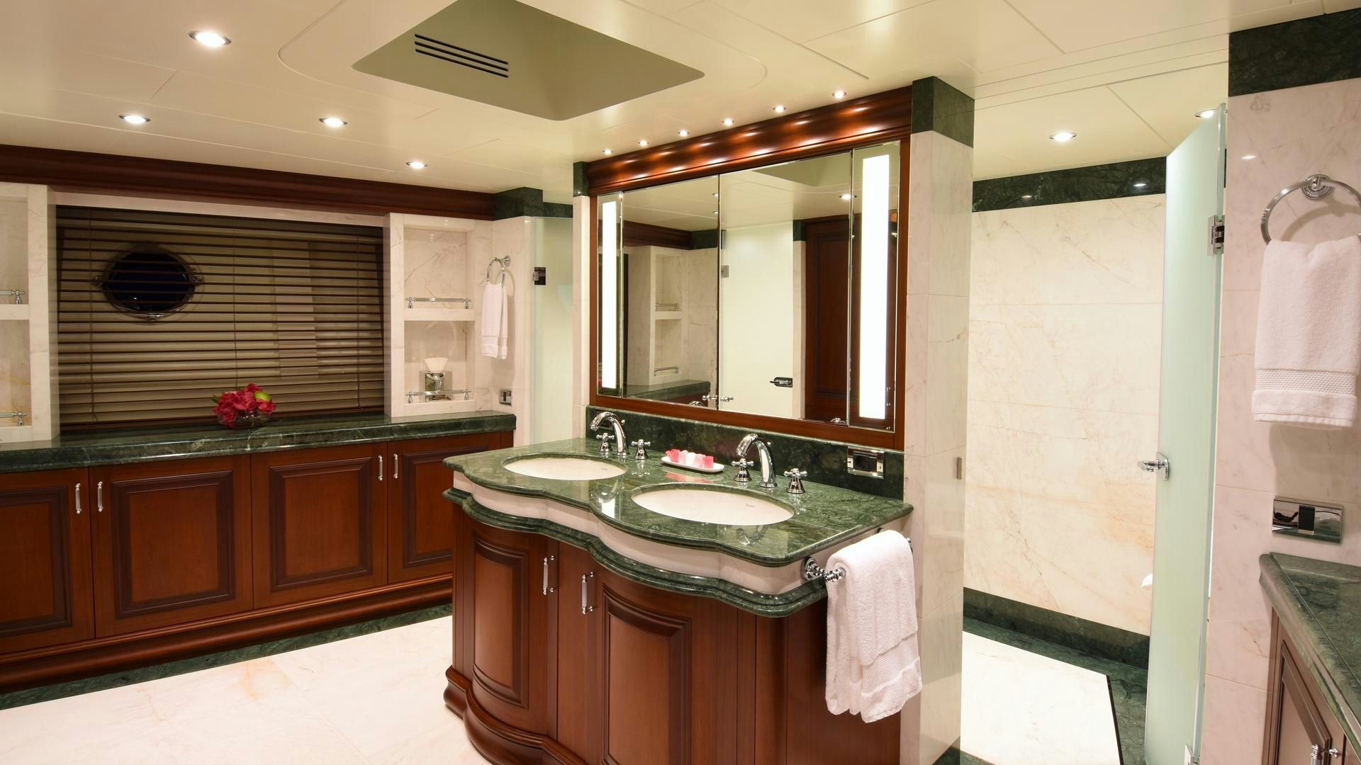 a bathroom with a large mirror aboard OMNIA Yacht for Sale