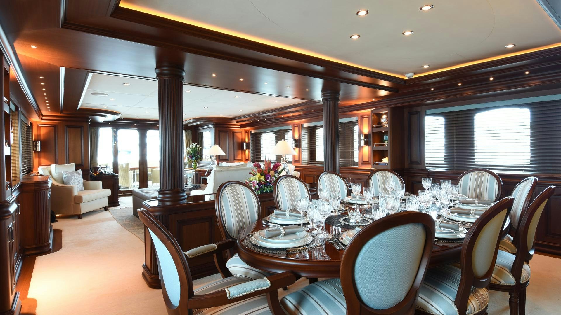 a large dining room with a large table and chairs aboard OMNIA Yacht for Sale