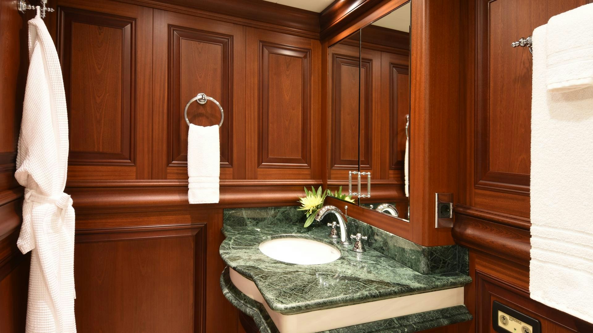 a bathroom with a sink and cabinets aboard OMNIA Yacht for Sale
