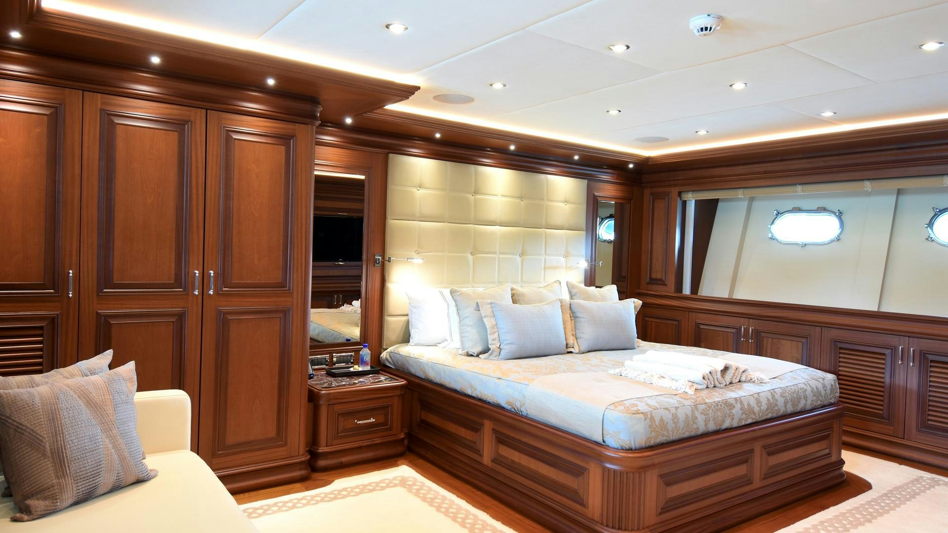 a large bed in a hotel room aboard OMNIA Yacht for Sale