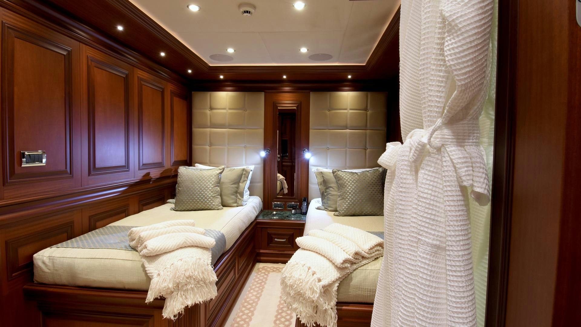 a room with a bed and a curtain aboard OMNIA Yacht for Sale