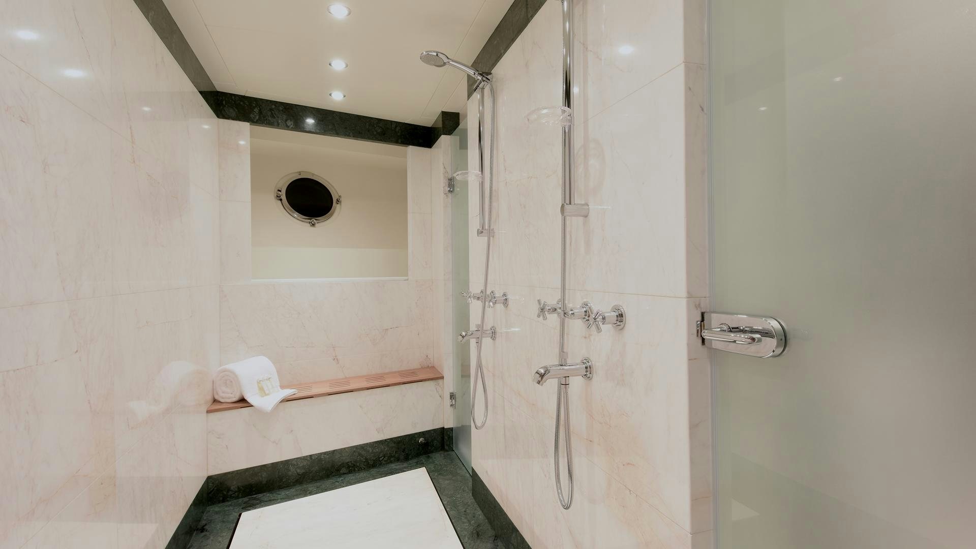 a bathroom with a shower aboard OMNIA Yacht for Sale