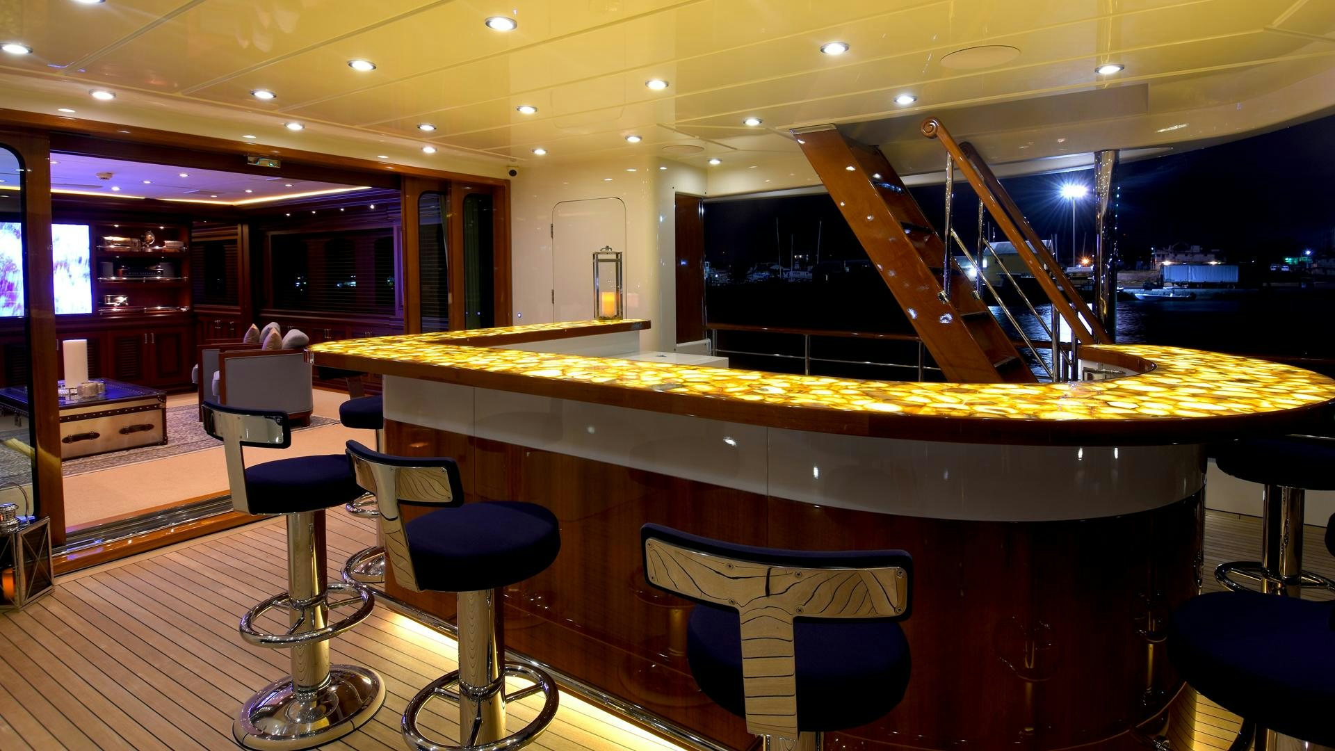a room with a table and chairs aboard OMNIA Yacht for Sale