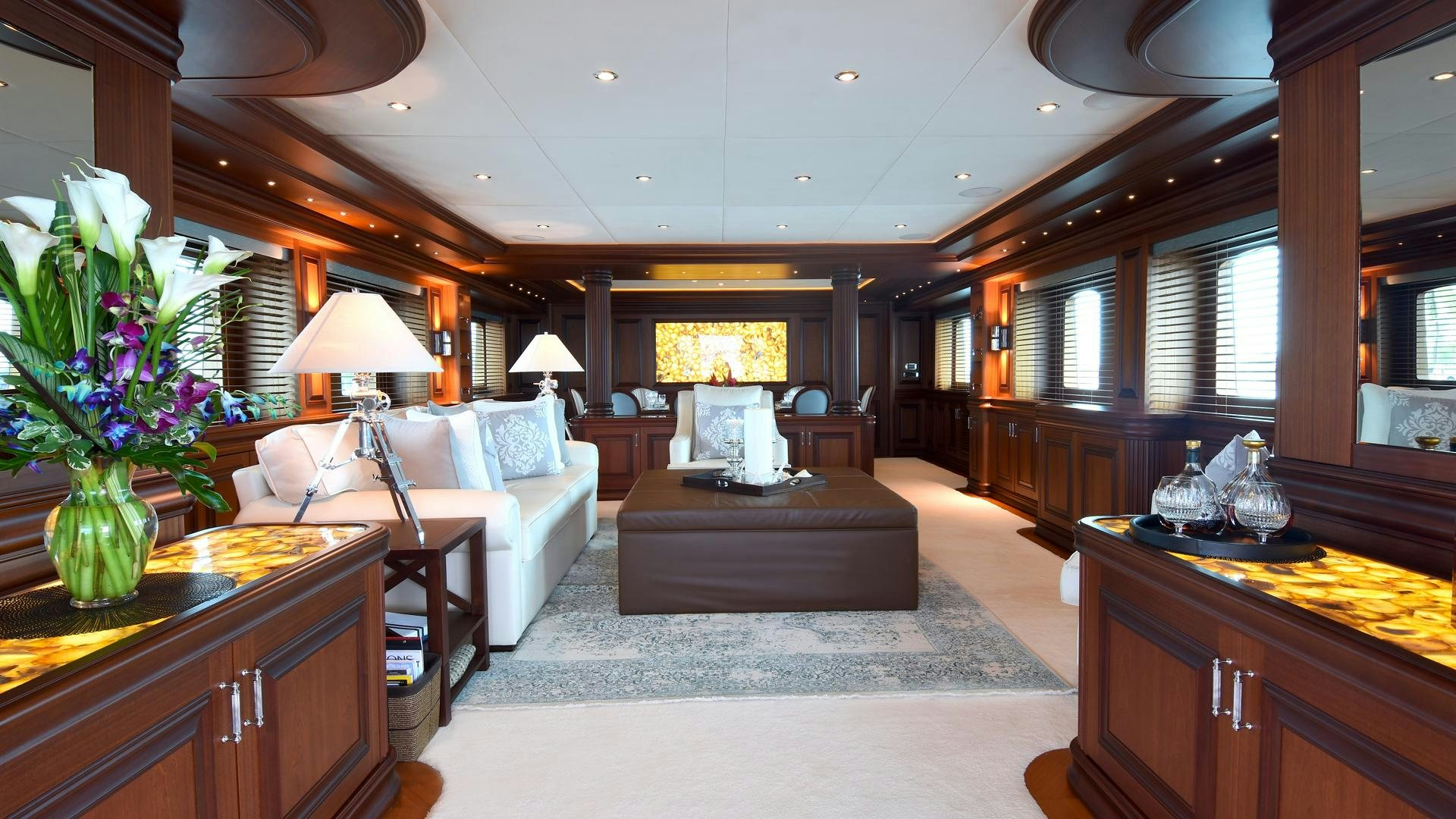 a living room with a couch and a piano aboard OMNIA Yacht for Sale