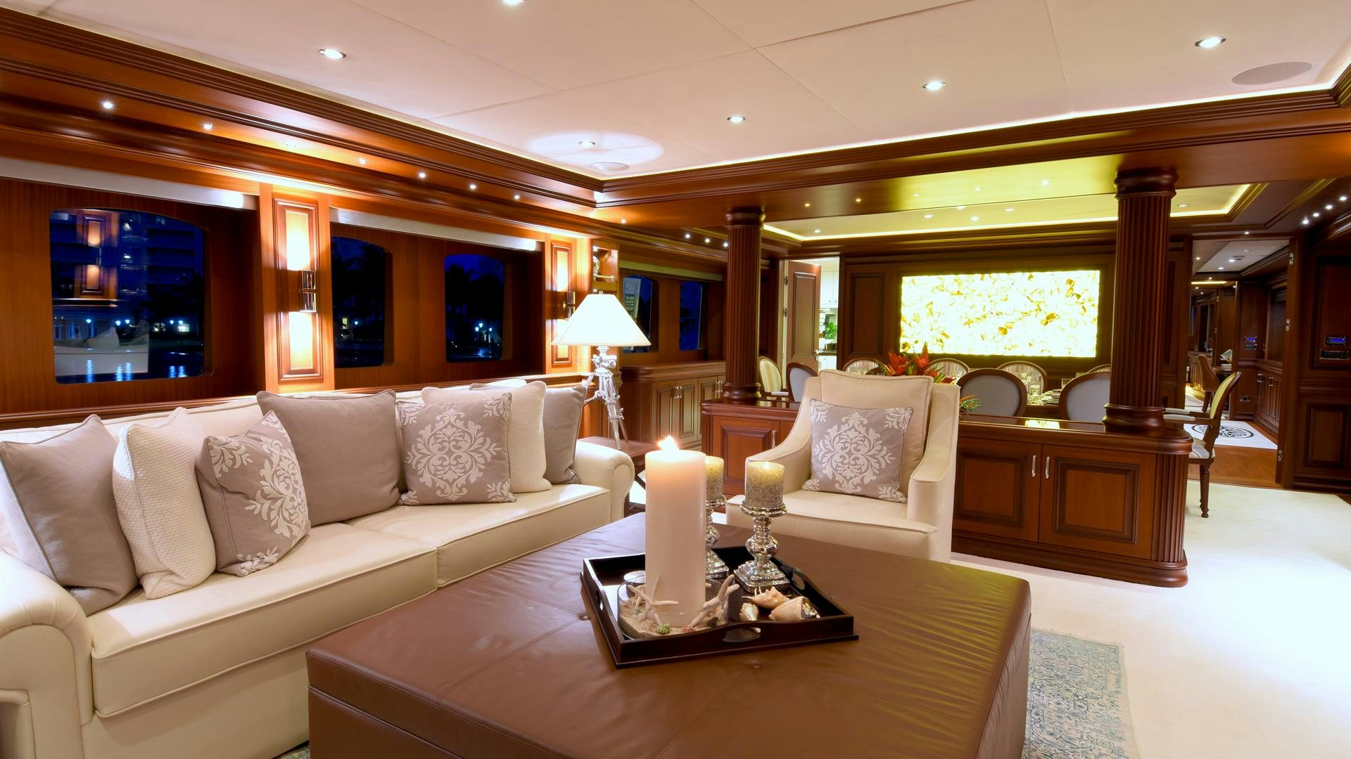 a living room with a large mirror aboard OMNIA Yacht for Sale