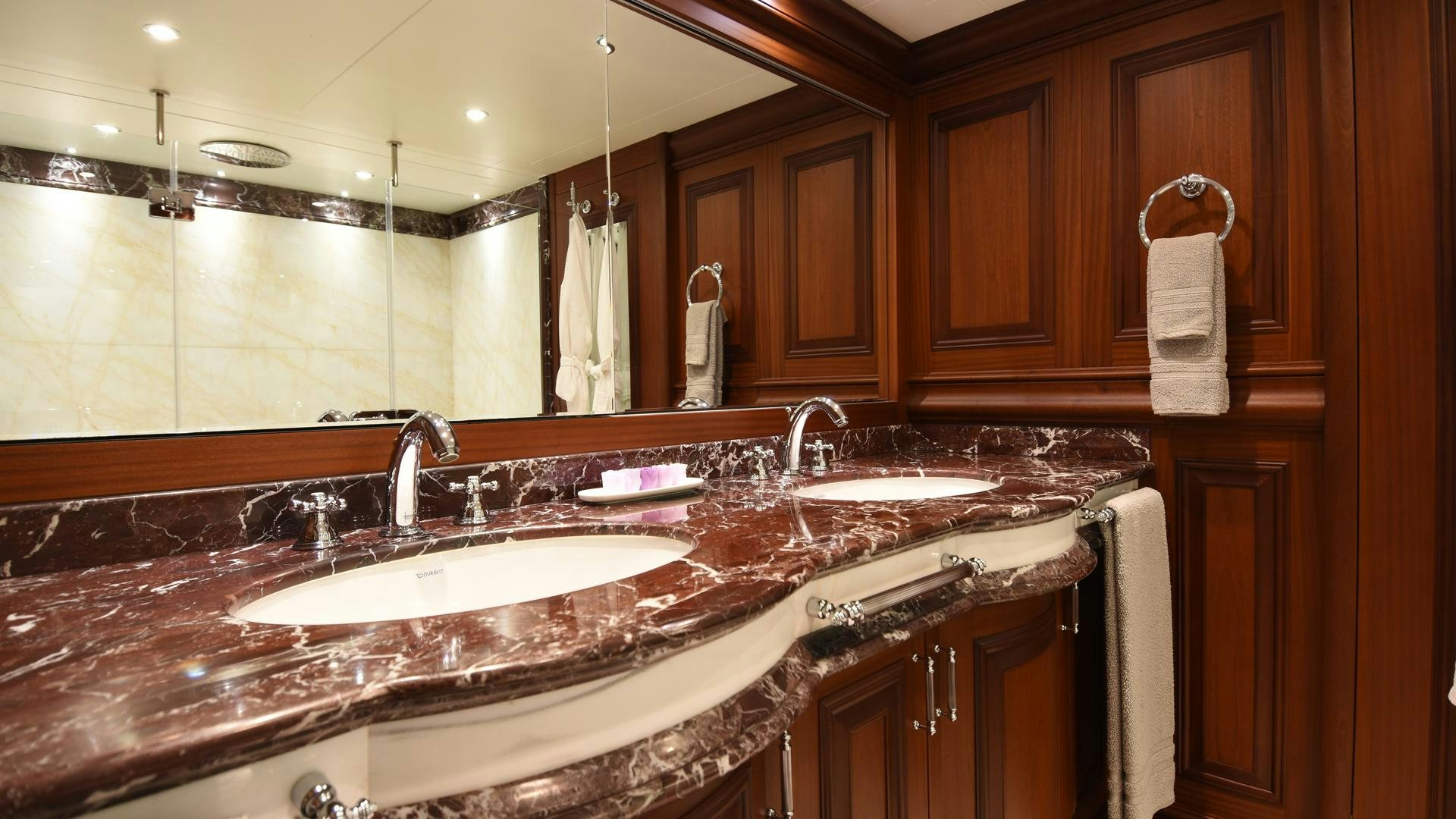 a bathroom with a countertop sink and cabinets aboard OMNIA Yacht for Sale
