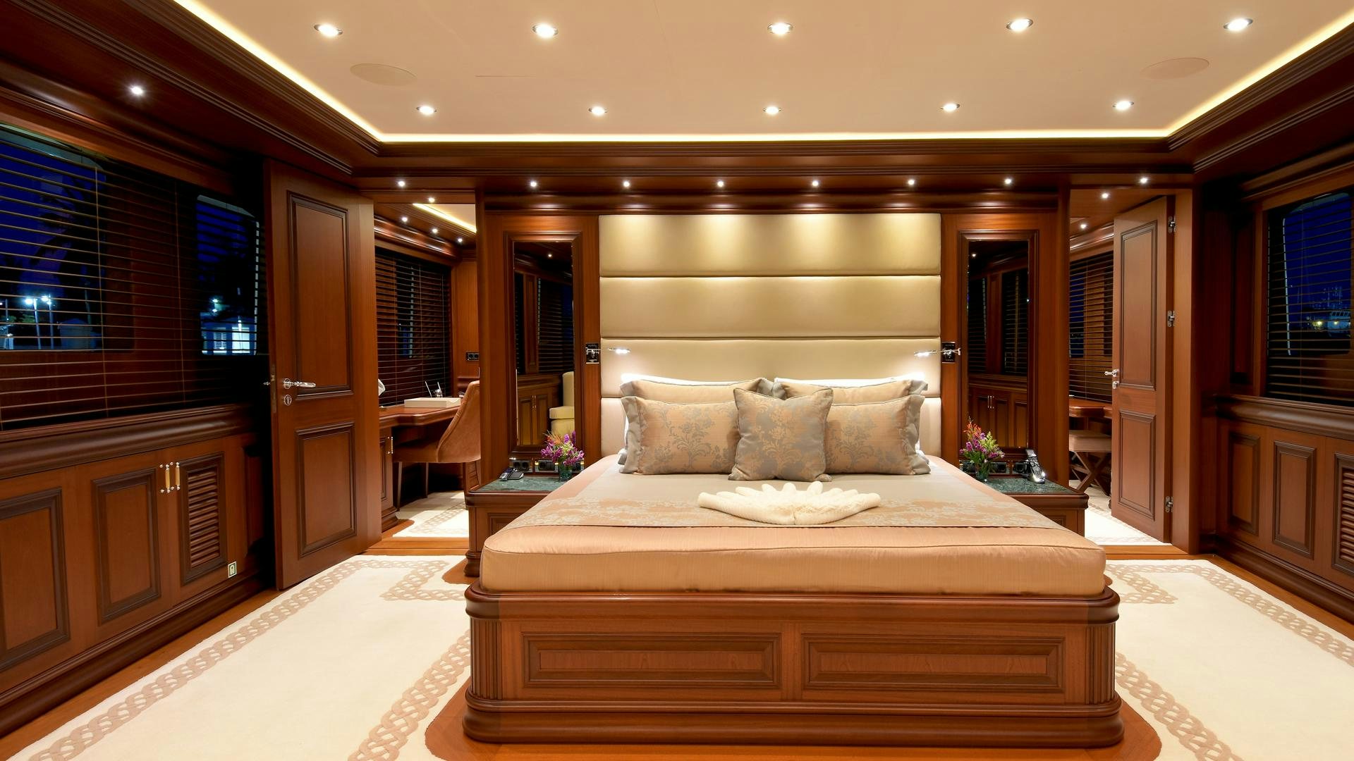 a large bed in a hotel room aboard OMNIA Yacht for Sale