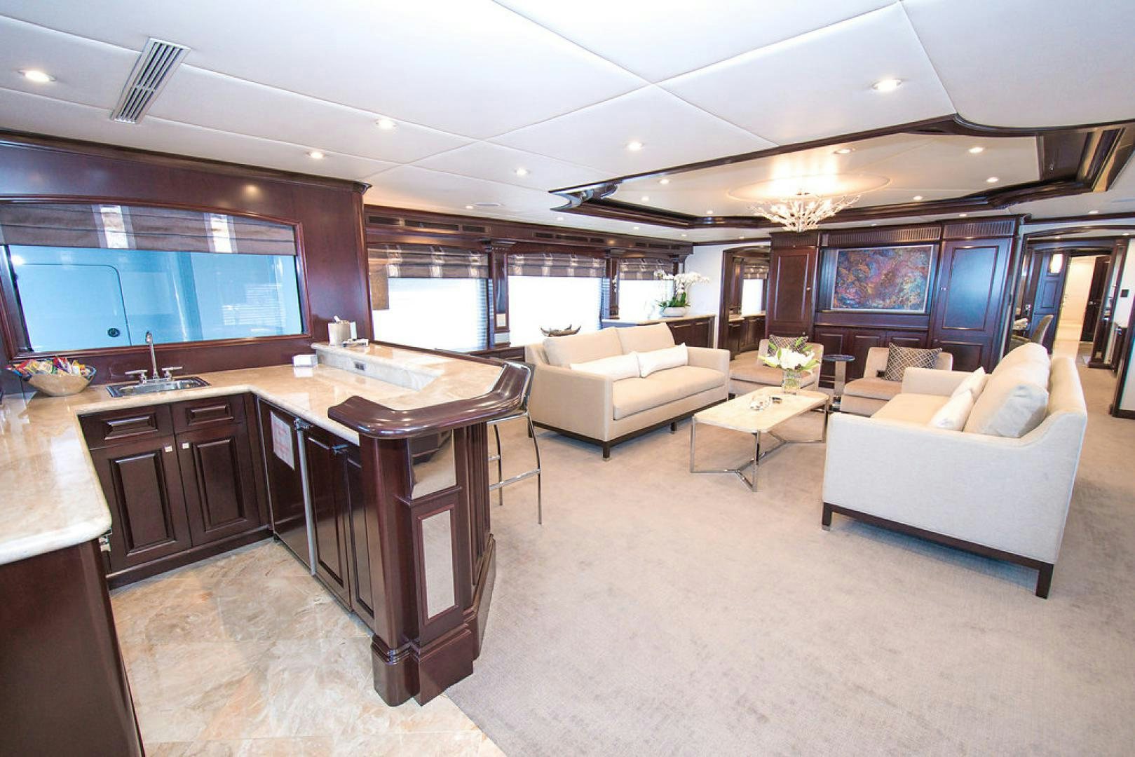 a large living room with a large table and chairs aboard REBEL Yacht for Sale