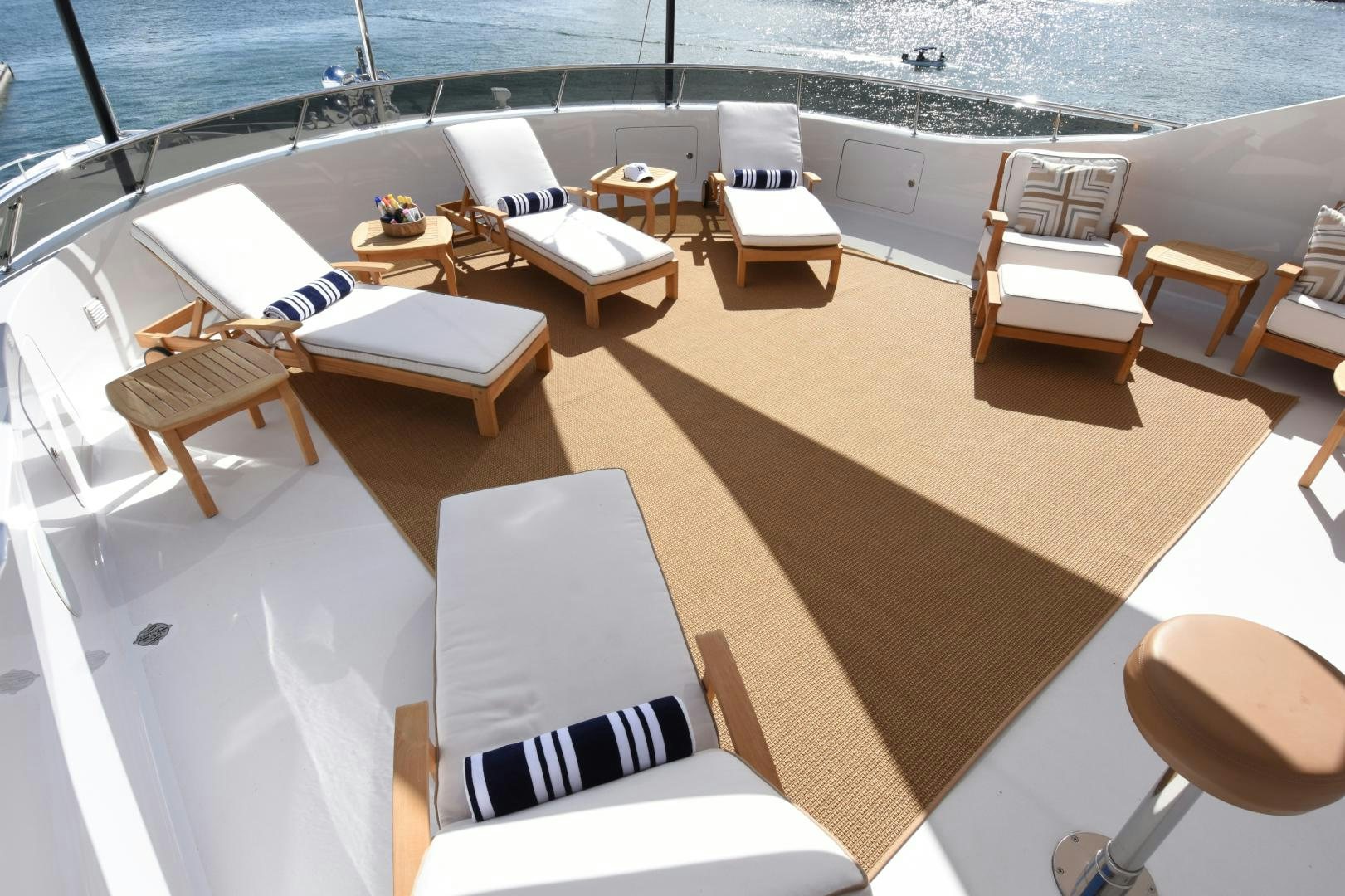 a room with a deck and chairs aboard REBEL Yacht for Sale