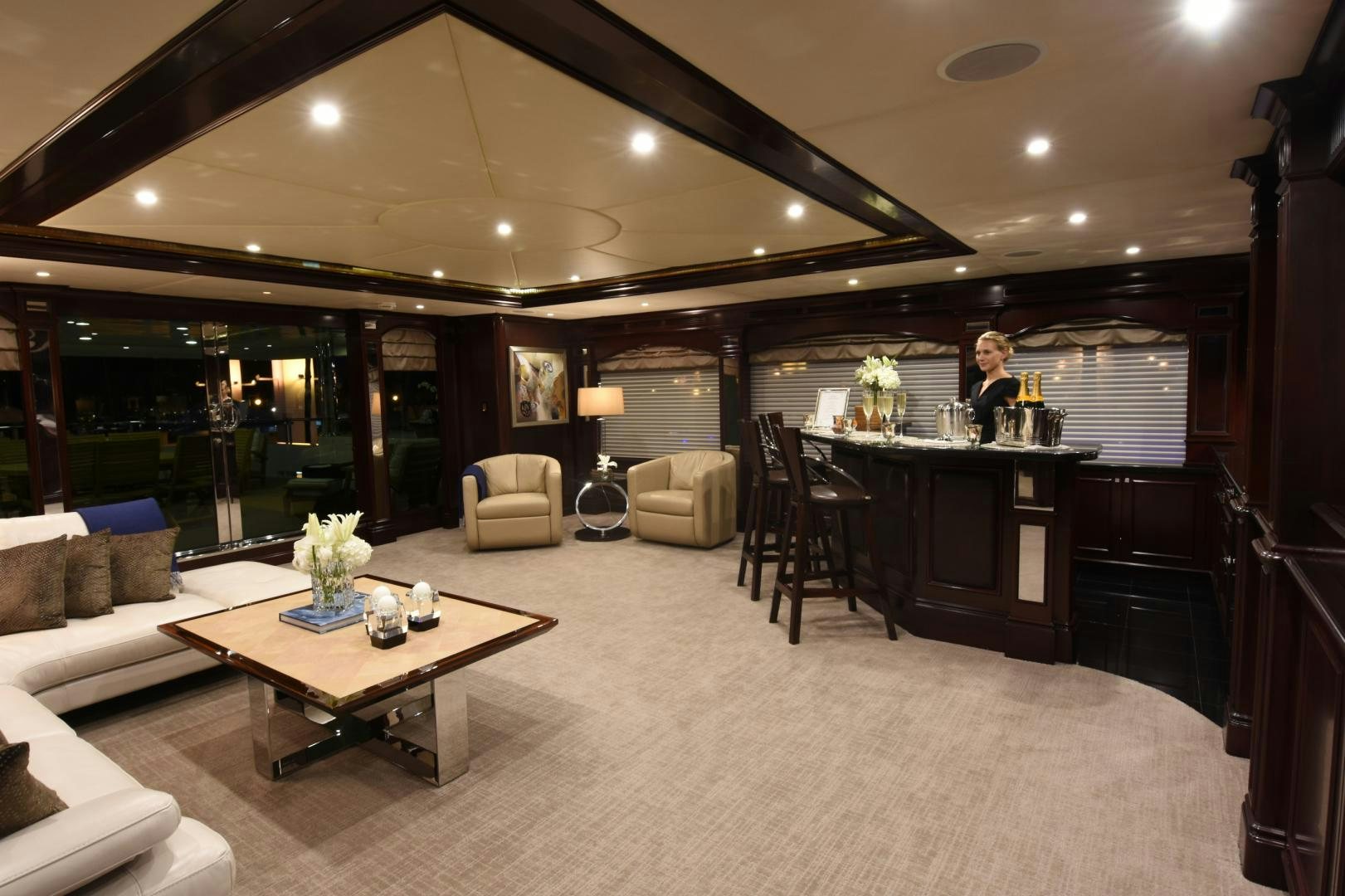 a person standing in a large living room aboard REBEL Yacht for Sale