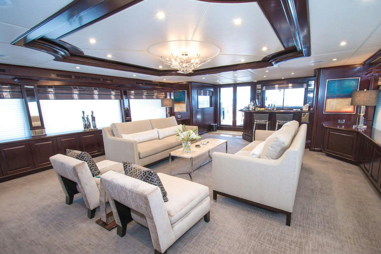 a living room with white furniture aboard REBEL Yacht for Sale