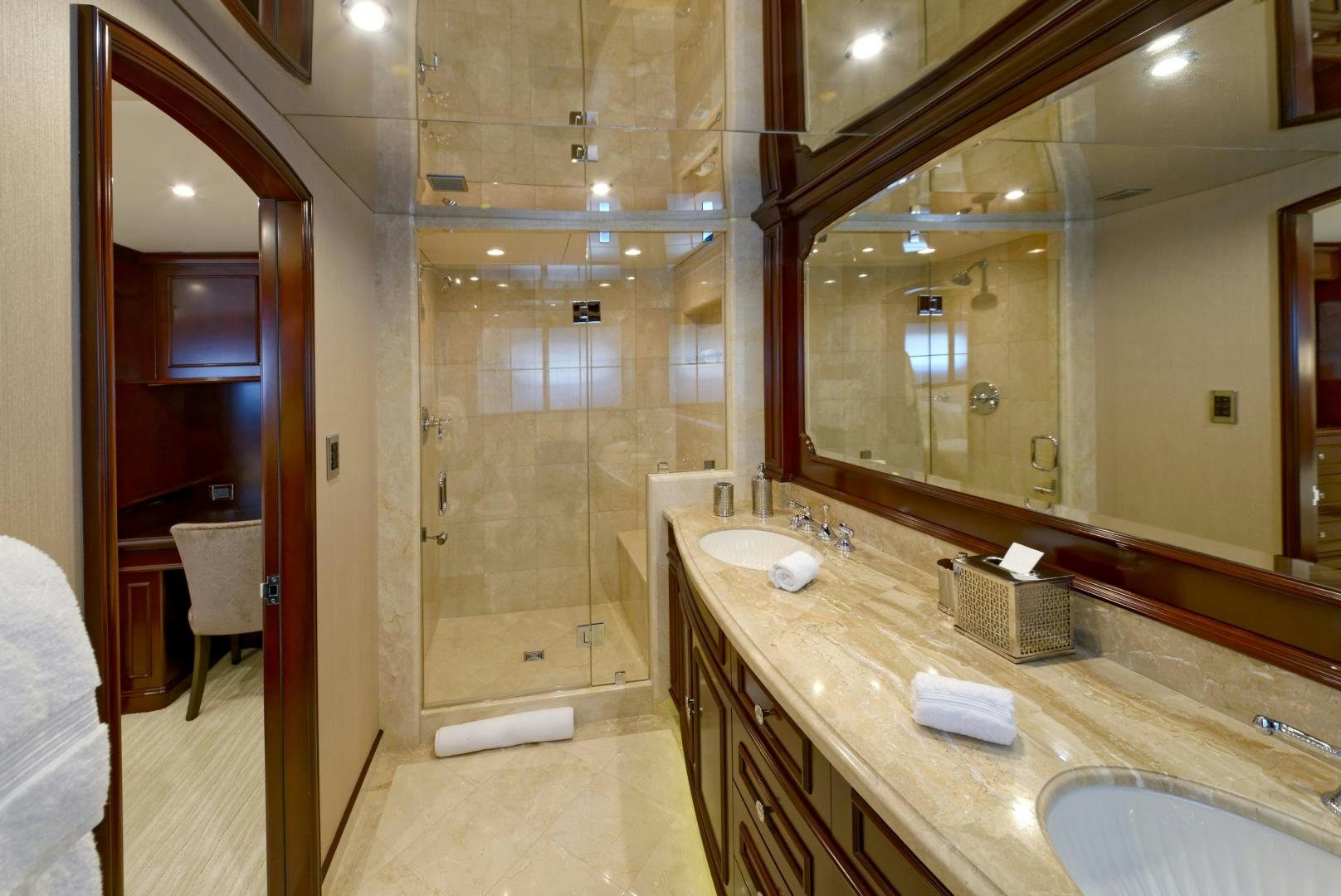 a bathroom with a countertop sink and mirrors aboard REBEL Yacht for Sale