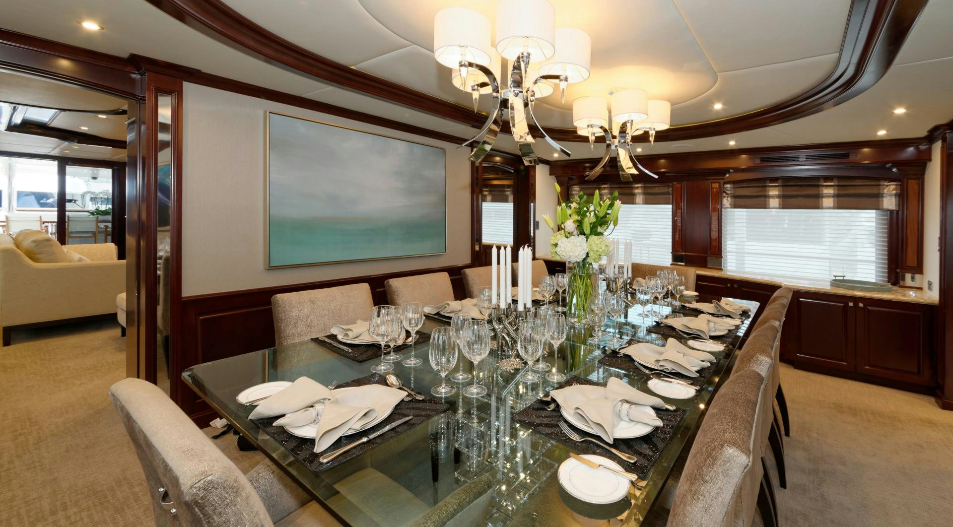 a dining table with a large screen aboard REBEL Yacht for Sale