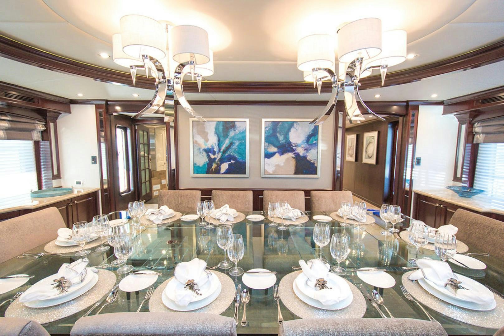 a table with plates and glasses aboard REBEL Yacht for Sale