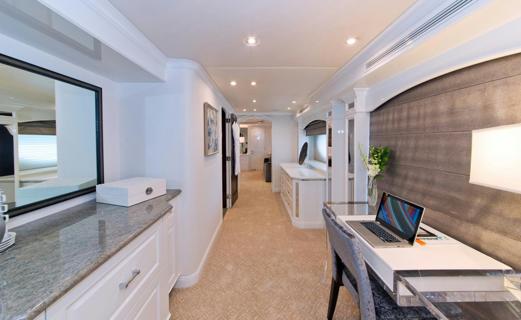 a room with a desk and a laptop on a table aboard REBEL Yacht for Sale
