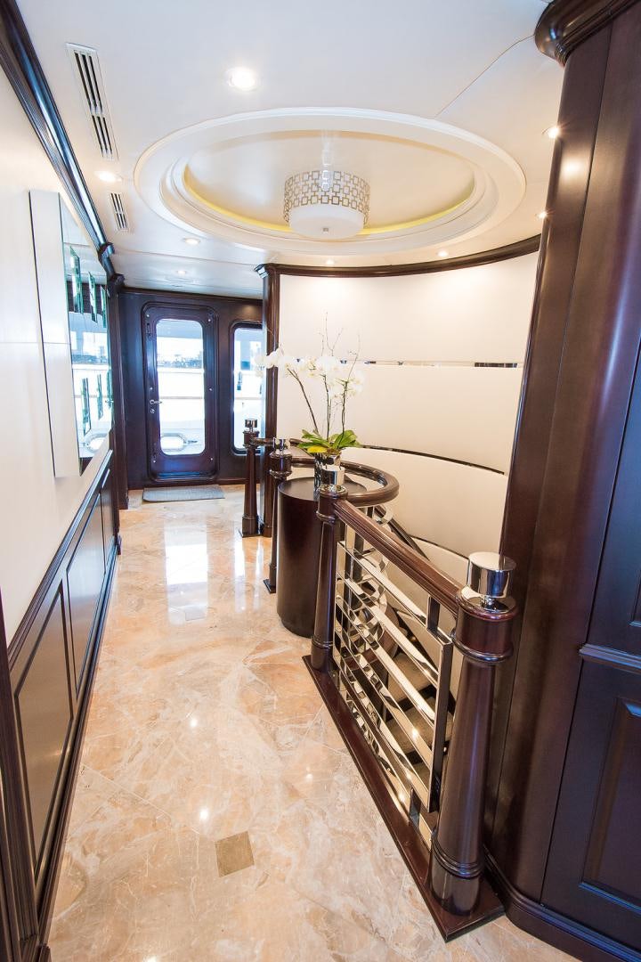 a hallway with a chandelier aboard REBEL Yacht for Sale