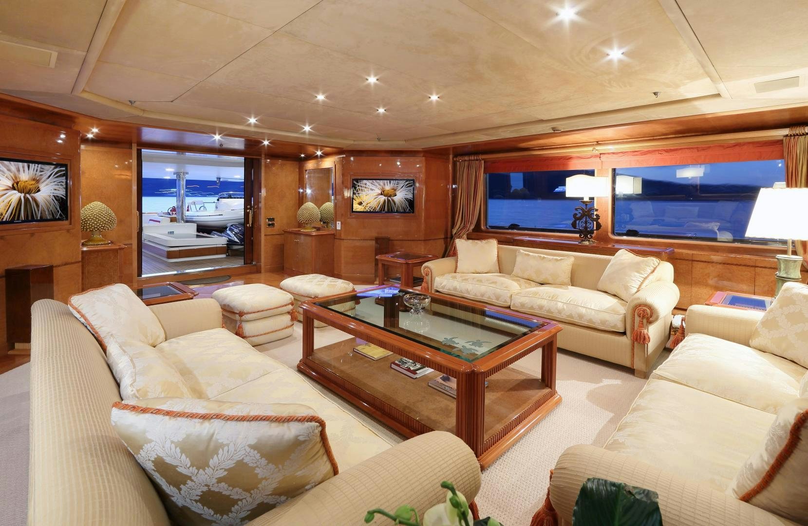 a living room with a table and couches aboard DR NO NO Yacht for Sale