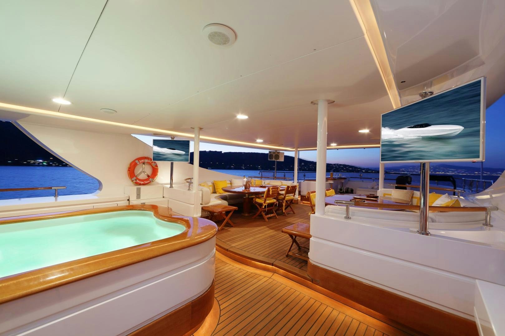 a room with a pool table and chairs and a large screen aboard DR NO NO Yacht for Sale