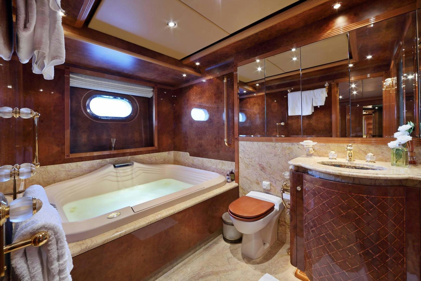 a bathroom with a tub sink and toilet aboard DR NO NO Yacht for Sale