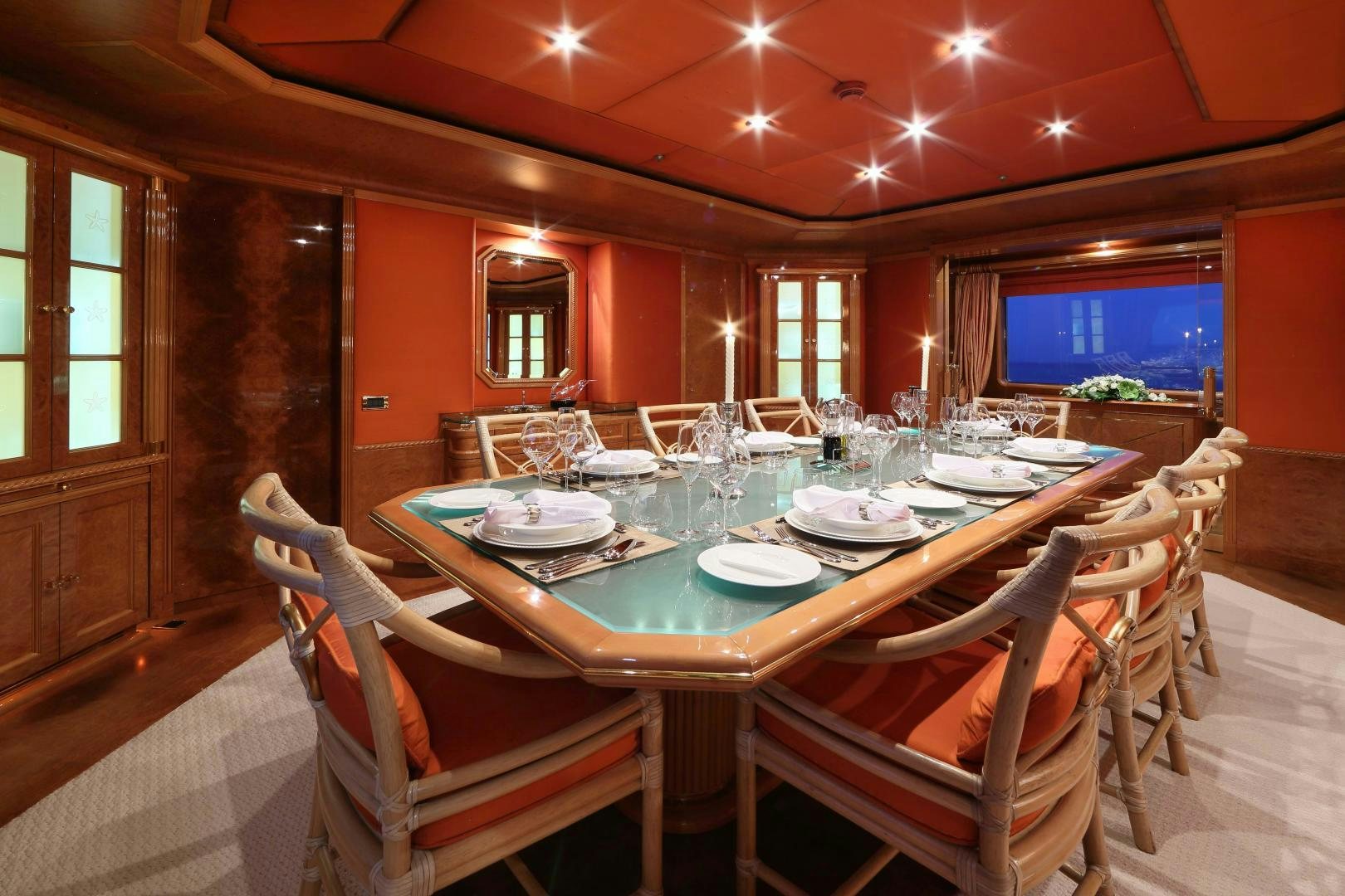 a dining room with a table set for dinner aboard DR NO NO Yacht for Sale