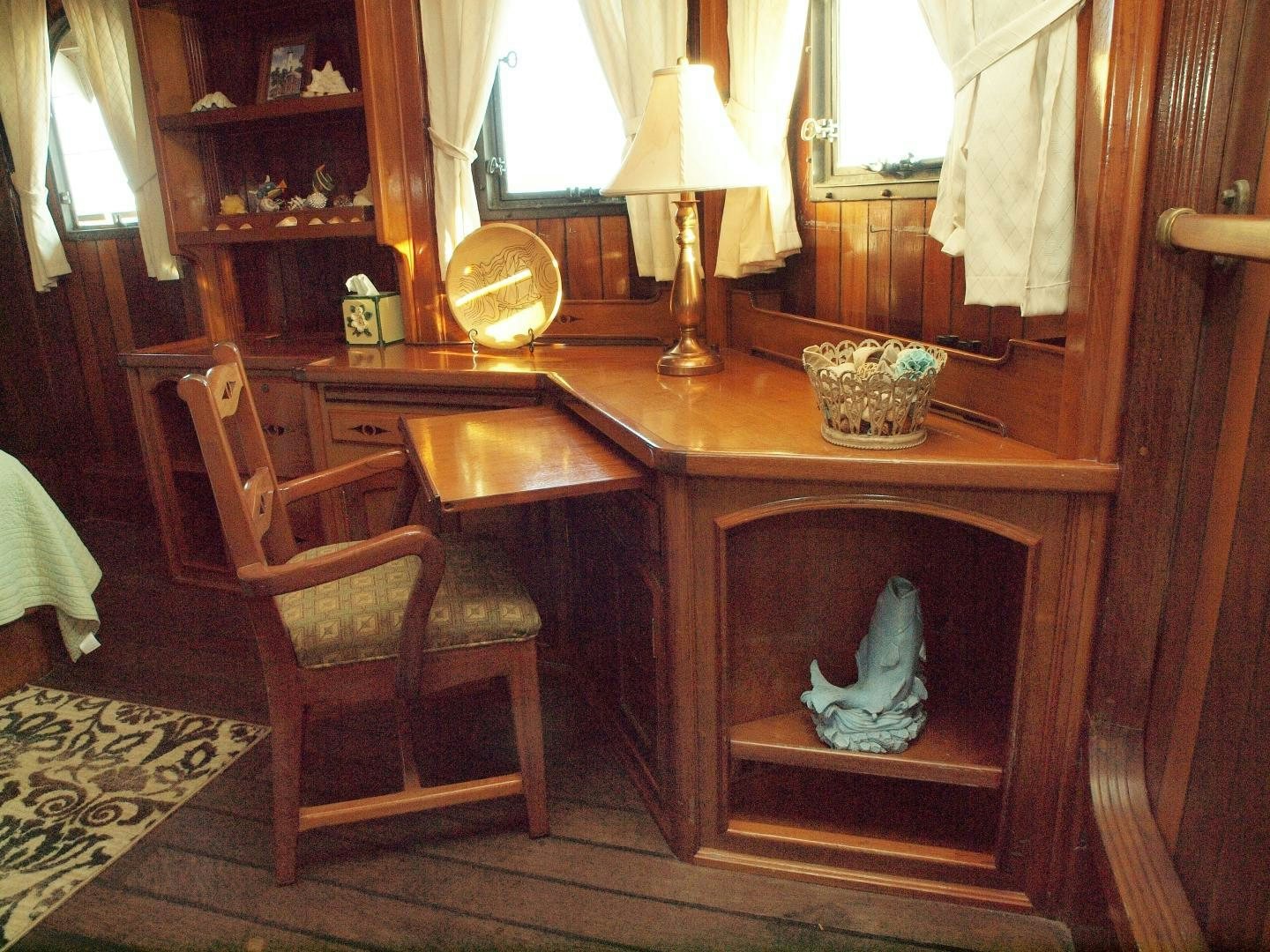 a desk with a chair and a lamp on it aboard PEACEMAKER Yacht for Sale
