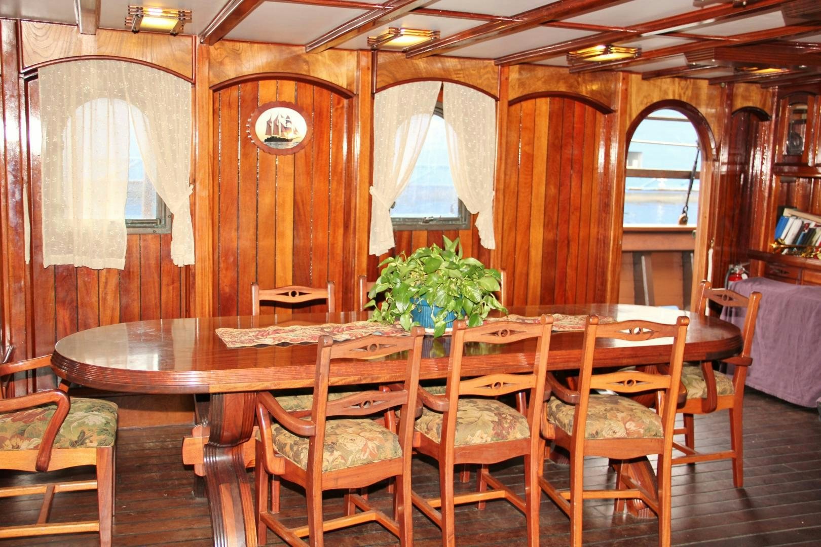 a dining room with a table and chairs aboard PEACEMAKER Yacht for Sale