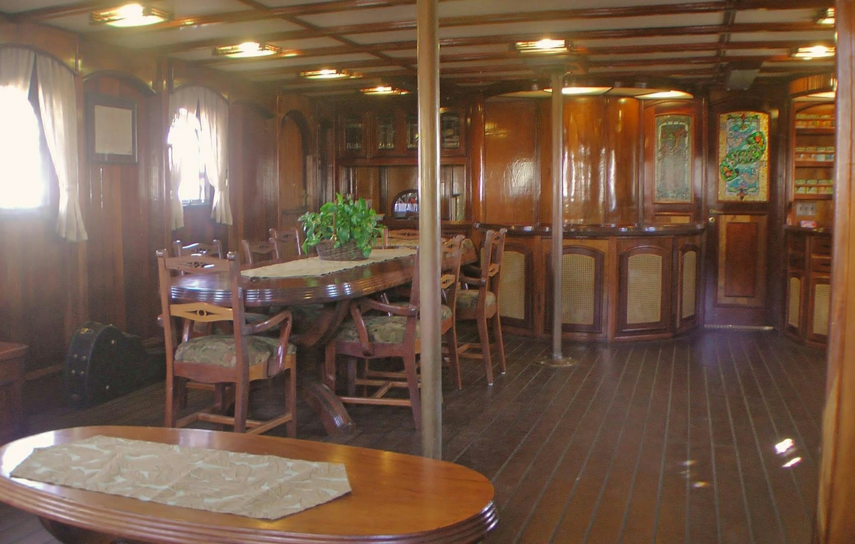 a restaurant with tables and chairs aboard PEACEMAKER Yacht for Sale