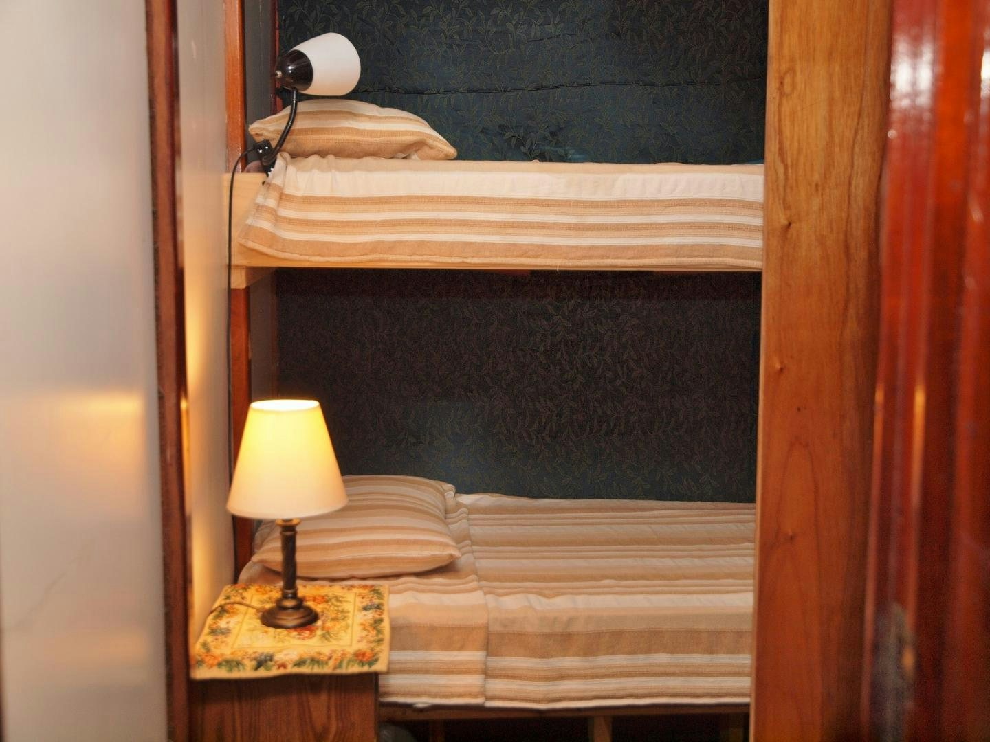 a bed with a lamp on it aboard PEACEMAKER Yacht for Sale