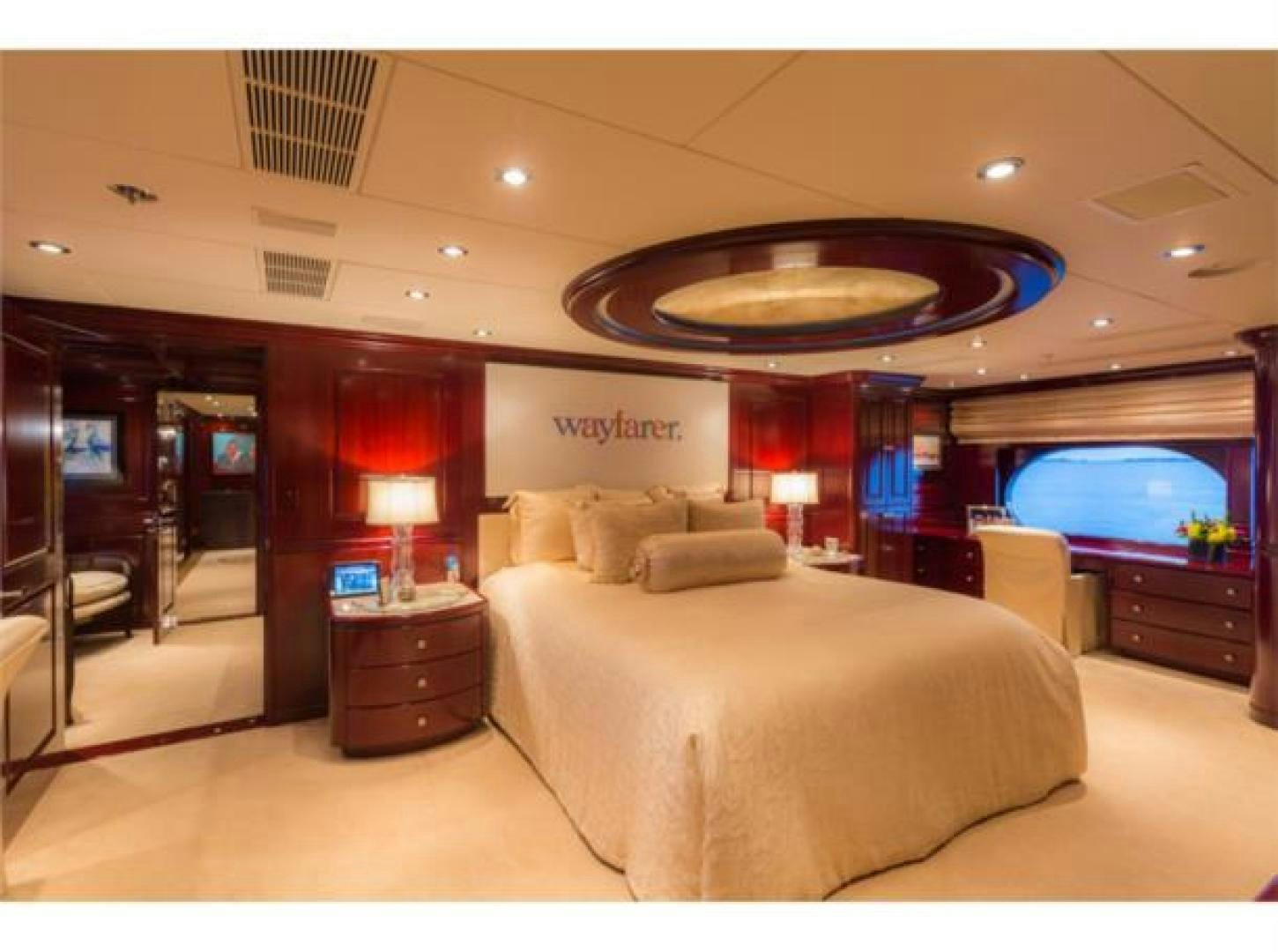 a hotel room with a bed and a television aboard LADY JOY Yacht for Sale