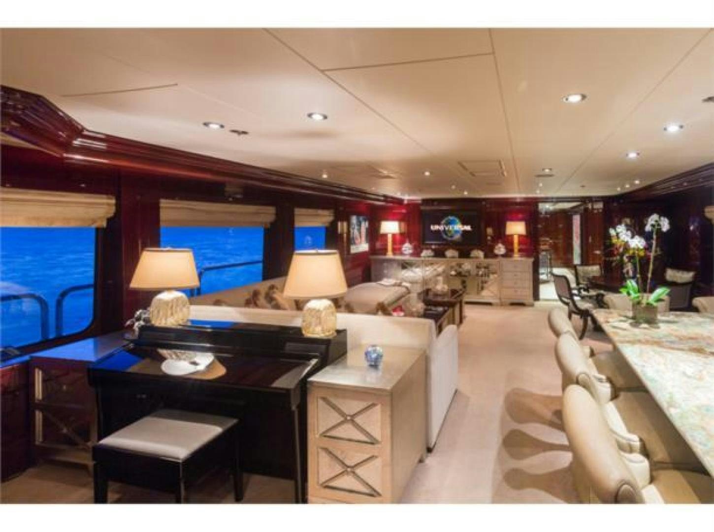 a living room with a large screen aboard LADY JOY Yacht for Sale