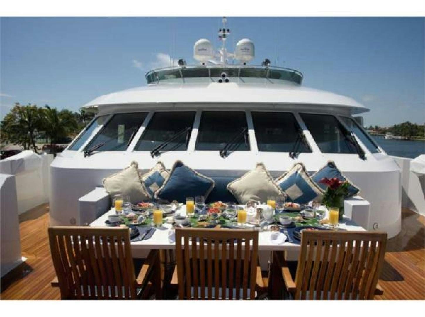 a white car with a large white boat on top aboard LADY JOY Yacht for Sale