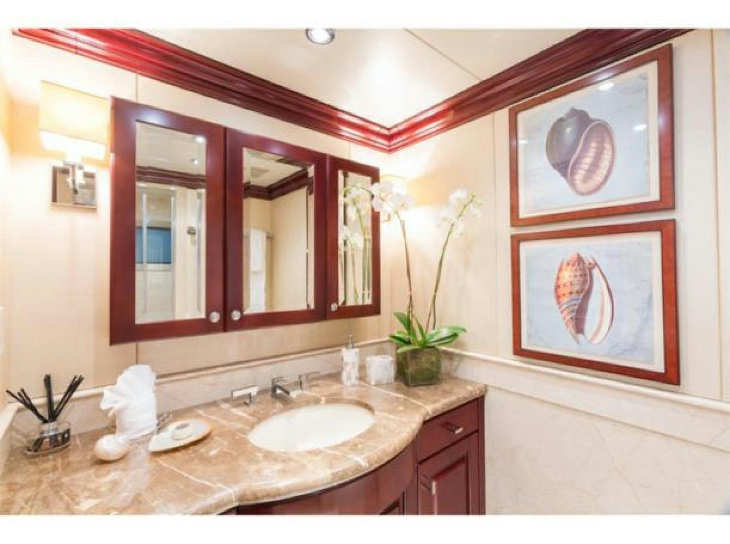 a bathroom with a sink and mirror aboard LADY JOY Yacht for Sale