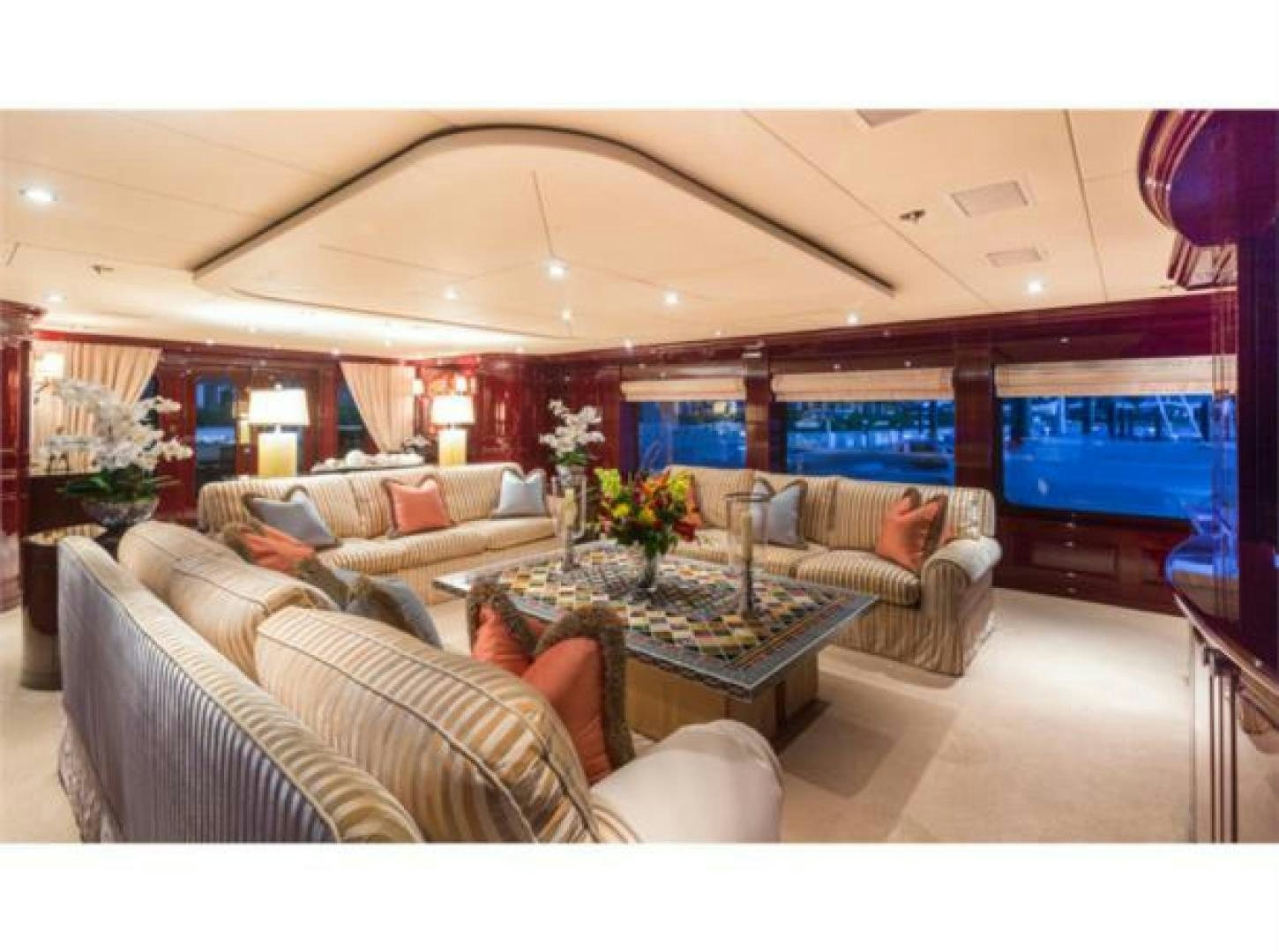 a living room with a large blue screen aboard LADY JOY Yacht for Sale